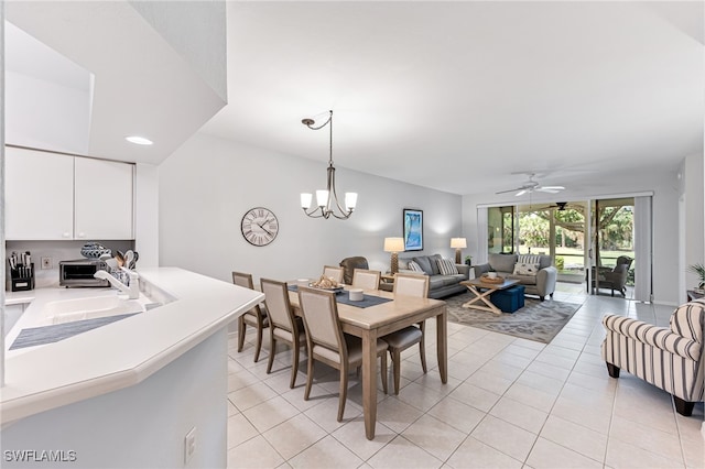 8115 Celeste Dr Unit 6110, Naples, FL 34113 - dining space with recessed lighting, ceiling fan with notable chandelier, light tile patterned floors, and a toaster