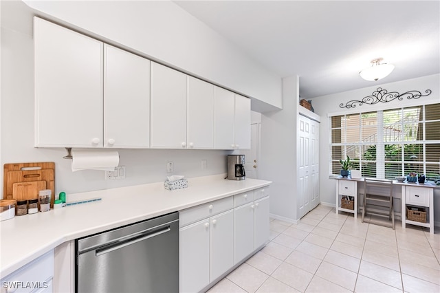 8115 Celeste Dr Unit 6110, Naples, FL 34113 - kitchen with stainless steel dishwasher, white cabinetry, light tile patterned floors, and light countertops