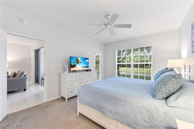 8115 Celeste Dr Unit 6110, Naples, FL 34113 - bedroom featuring baseboards, ceiling fan, light carpet, and light tile patterned floors