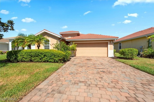 single story home with decorative driveway, an attached garage, a front lawn, and stucco siding