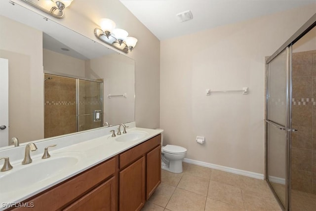 full bathroom featuring a sink, tile patterned flooring, a shower stall, and double vanity