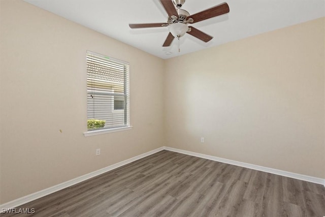 unfurnished room featuring baseboards, a ceiling fan, and wood finished floors