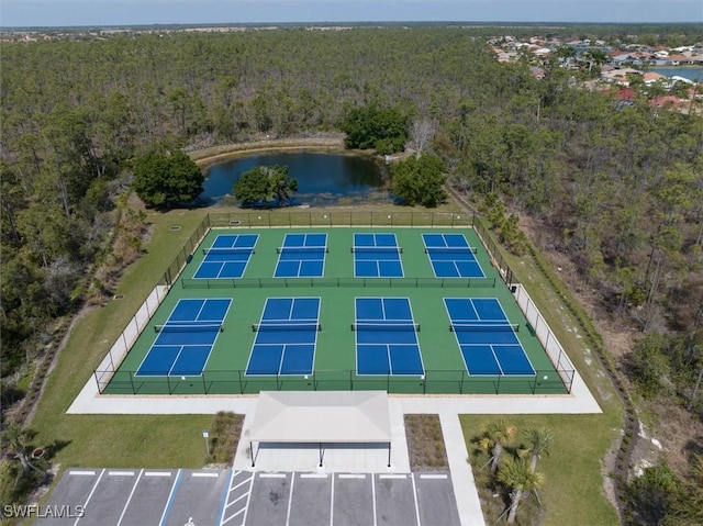 birds eye view of property with a water view and a view of trees