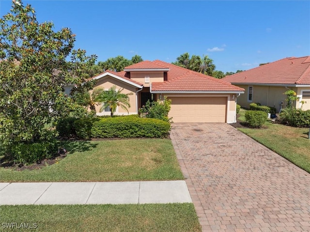 mediterranean / spanish-style home featuring a front yard, decorative driveway, stucco siding, an attached garage, and a tile roof