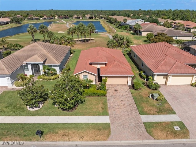 drone / aerial view with a residential view and a water view