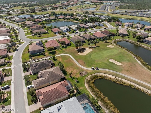 bird's eye view with a water view, view of golf course, and a residential view