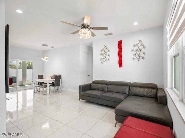 27257 Pinecrest Ln, Bonita Springs, FL 34135 - living room with ceiling fan, visible vents, baseboards, marble finish floor, and recessed lighting