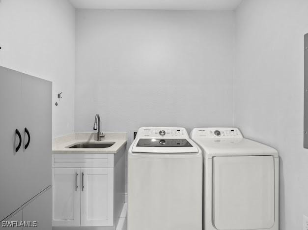 27257 Pinecrest Ln, Bonita Springs, FL 34135 - laundry room featuring a sink, cabinet space, and washing machine and dryer