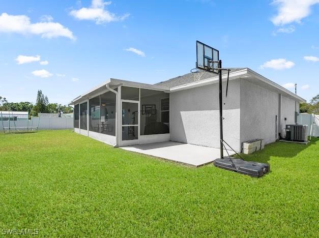 27257 Pinecrest Ln, Bonita Springs, FL 34135 - rear view of house with a lawn, fence, and a sunroom