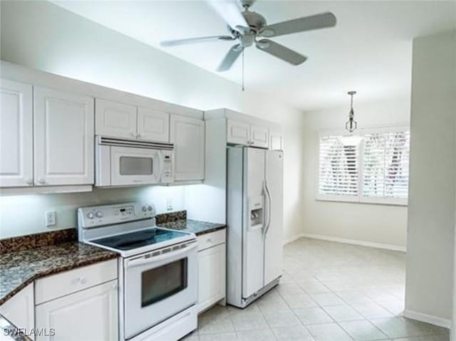 kitchen with light tile patterned flooring, white appliances, baseboards, ceiling fan, and decorative light fixtures