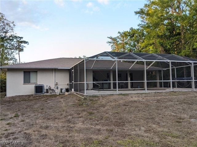 back of house featuring a patio, central AC, a lanai, and stucco siding
