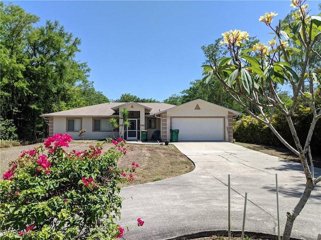 single story home with a garage, stucco siding, and driveway