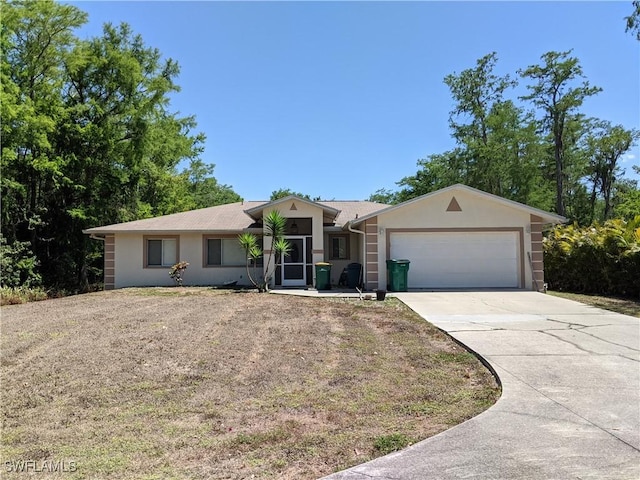 ranch-style house with a garage, stucco siding, and driveway