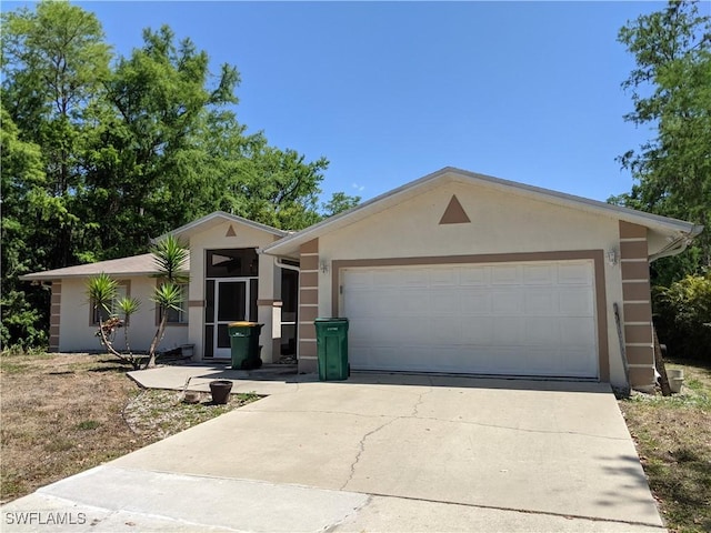 view of front of home featuring an attached garage, driveway, and stucco siding