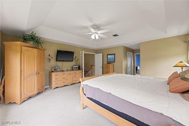 12541 Allendale Cir, Fort Myers, FL 33912 - bedroom featuring a tray ceiling, baseboards, ceiling fan, visible vents, and light carpet