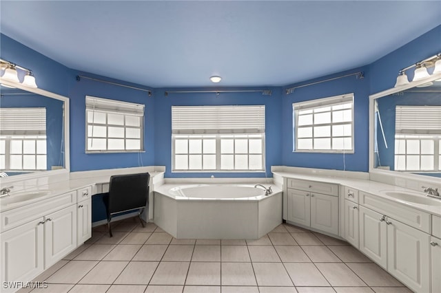 12541 Allendale Cir, Fort Myers, FL 33912 - bathroom with two vanities, tile patterned floors, a garden tub, and a sink