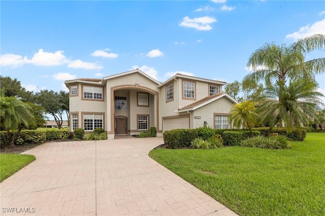 12541 Allendale Cir, Fort Myers, FL 33912 - view of front of home with a front lawn, stucco siding, a garage, and decorative driveway