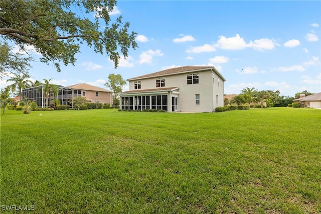 12541 Allendale Cir, Fort Myers, FL 33912 - back of house featuring a yard, a sunroom, and stucco siding