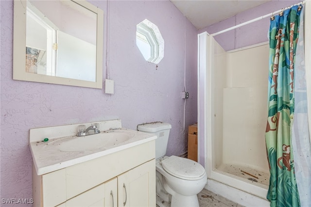 full bath featuring vanity, toilet, and a stall shower