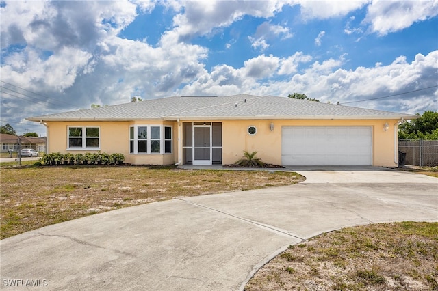 single story home with concrete driveway, fence, and stucco siding