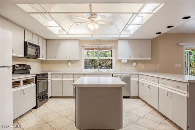 kitchen featuring light countertops, ceiling fan, light tile patterned floors, and black appliances