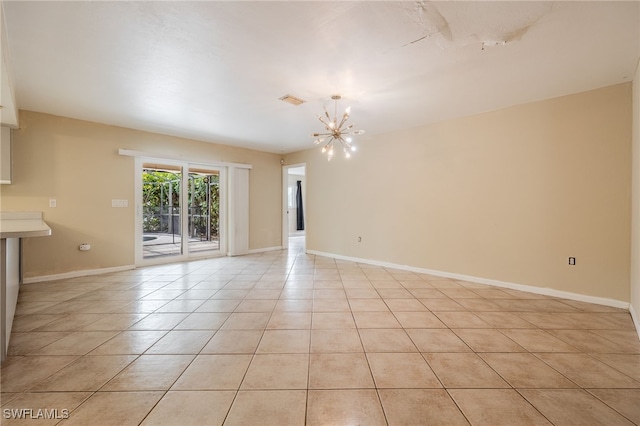 spare room with baseboards, visible vents, light tile patterned flooring, and a chandelier