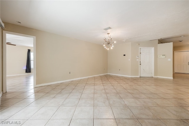 spare room with light tile patterned floors, baseboards, visible vents, and a notable chandelier