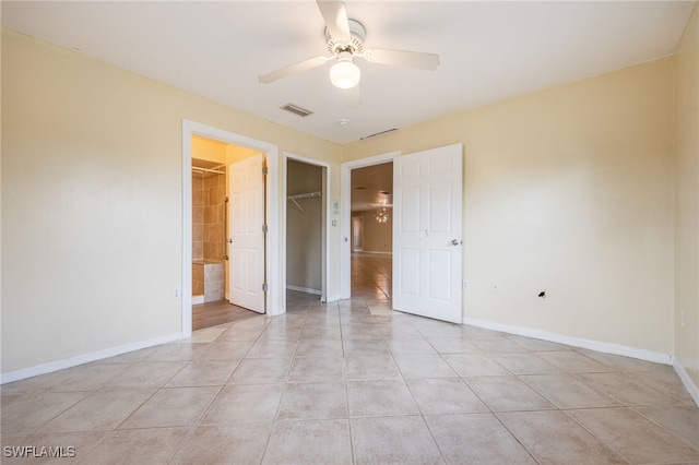 unfurnished bedroom with a closet, visible vents, baseboards, ceiling fan, and light tile patterned floors