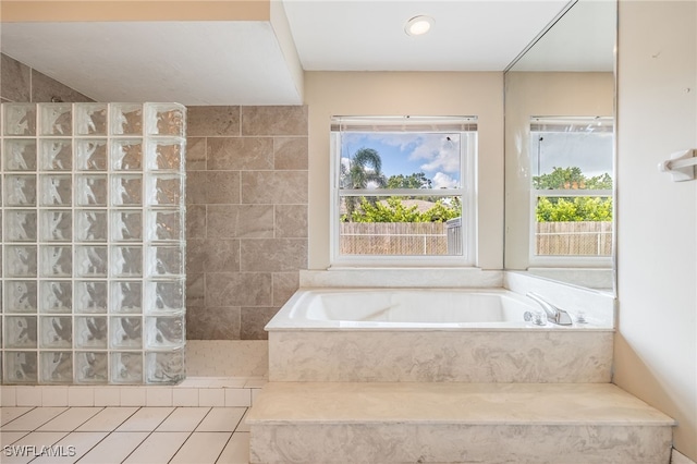 full bath featuring a garden tub, a walk in shower, and tile patterned floors