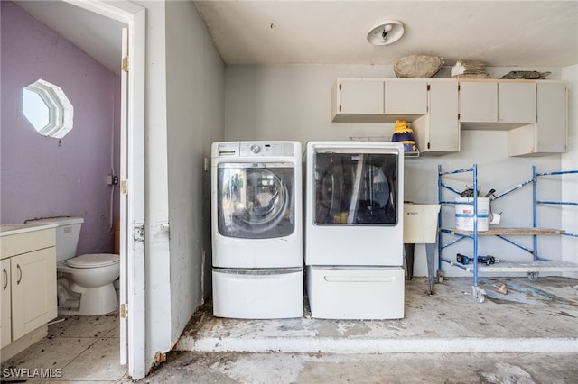 laundry area with cabinet space and washer and clothes dryer