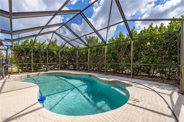 outdoor pool with a lanai and a patio