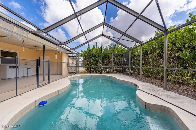 pool with a patio area, a lanai, and exterior kitchen
