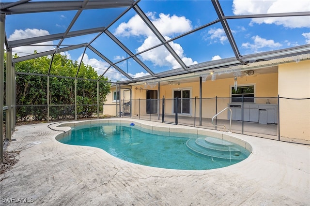 outdoor pool featuring a lanai, a patio, and ceiling fan