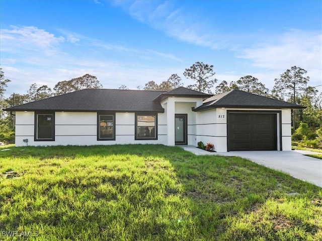 prairie-style house with an attached garage, stucco siding, a front yard, and concrete driveway