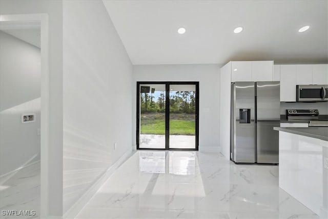 kitchen featuring appliances with stainless steel finishes, modern cabinets, white cabinetry, and marble finish floor