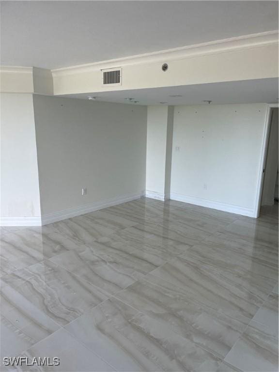unfurnished room with baseboards