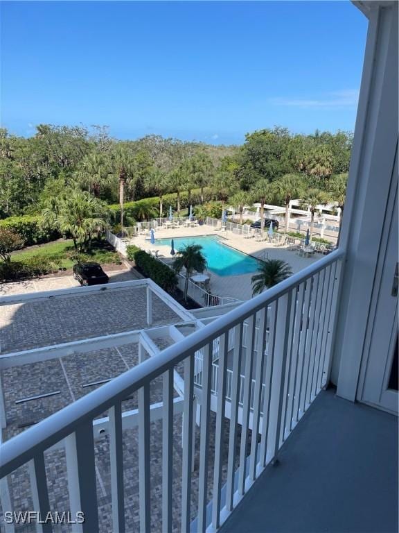 balcony featuring view of pool area