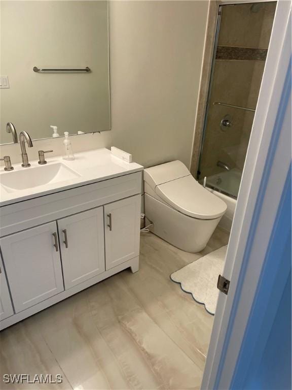 bathroom with vanity, toilet, and  shower combination
