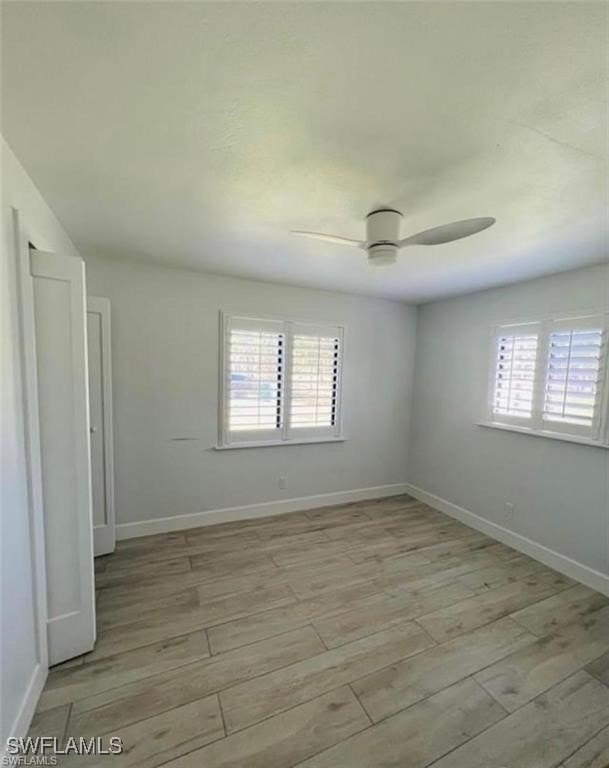 3650 1st Ave SW, Naples, FL 34117 - spare room with plenty of natural light, ceiling fan, and light wood-style floors