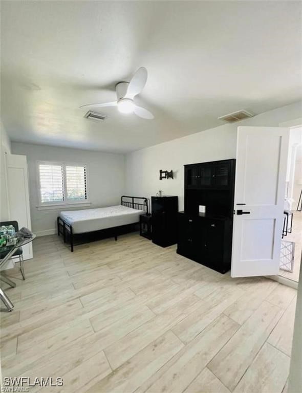 3650 1st Ave SW, Naples, FL 34117 - bedroom with light wood-style floors, visible vents, and ceiling fan
