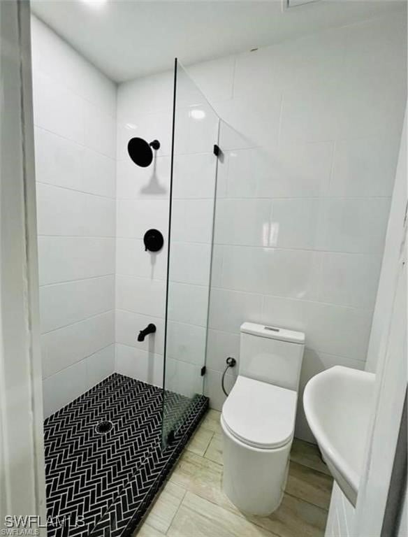3650 1st Ave SW, Naples, FL 34117 - full bathroom featuring toilet, tile walls, and a tile shower