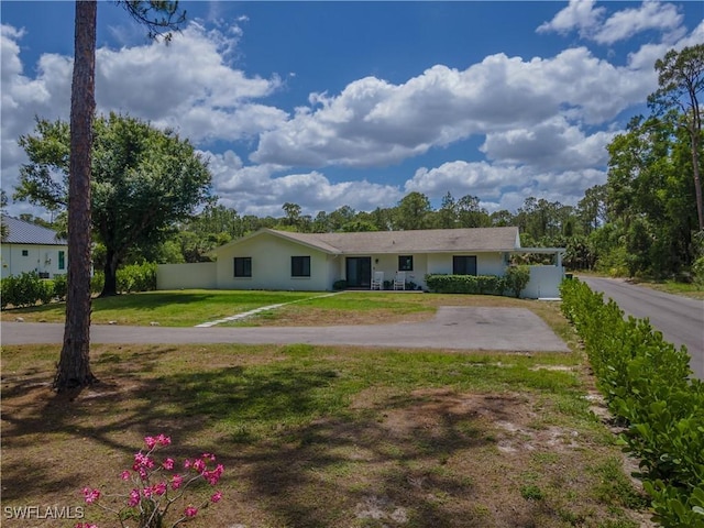 3650 1st Ave SW, Naples, FL 34117 - single story home featuring stucco siding, driveway, fence, and a front yard