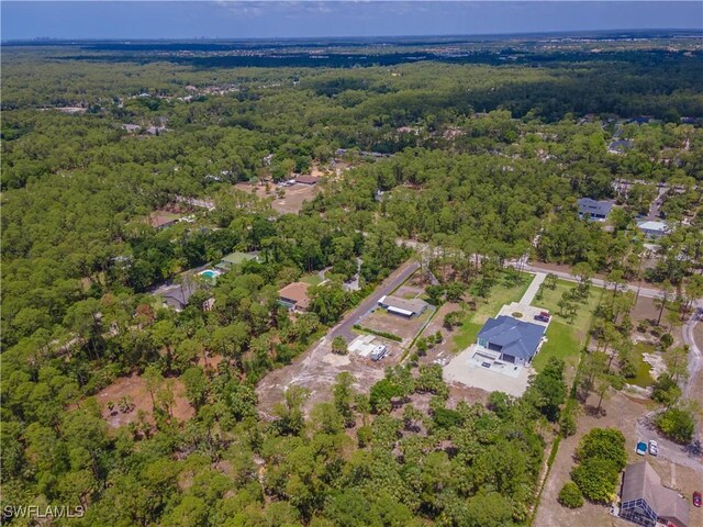 3650 1st Ave SW, Naples, FL 34117 - drone / aerial view featuring a forest view