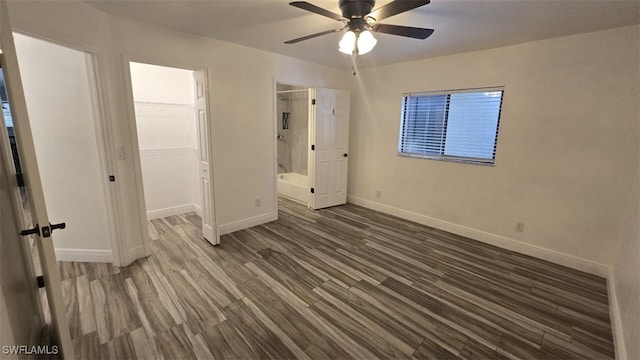 7311 Sean Ln, North Fort Myers, FL 33917 - unfurnished bedroom with baseboards, wood finished floors, a spacious closet, a closet, and a ceiling fan