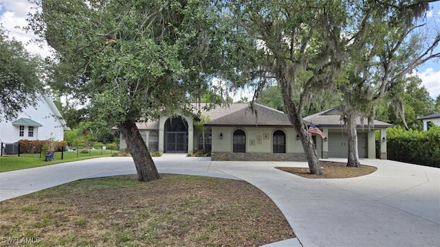 7311 Sean Ln, North Fort Myers, FL 33917 - view of front of home featuring curved driveway, stucco siding, and central AC unit