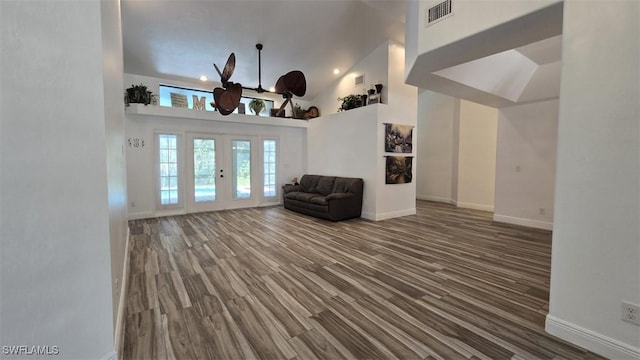 7311 Sean Ln, North Fort Myers, FL 33917 - living area with wood finished floors, baseboards, and a high ceiling