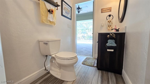 7311 Sean Ln, North Fort Myers, FL 33917 - half bathroom with toilet, wood finished floors, ceiling fan, baseboards, and vanity