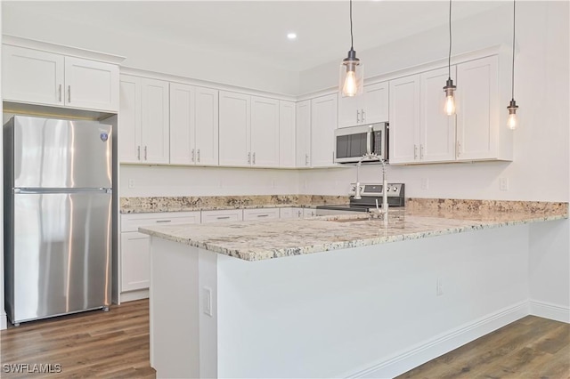 2174 Highland Ave, Fort Myers, FL 33916 - kitchen with appliances with stainless steel finishes, dark wood-style floors, white cabinets, a peninsula, and recessed lighting