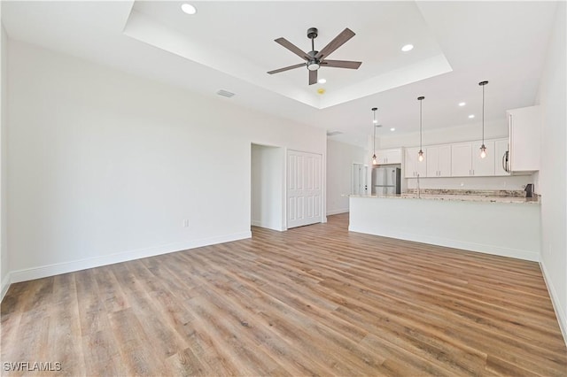 2174 Highland Ave, Fort Myers, FL 33916 - unfurnished living room featuring recessed lighting, a raised ceiling, a ceiling fan, light wood finished floors, and baseboards