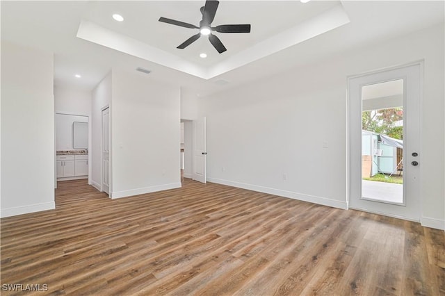 2174 Highland Ave, Fort Myers, FL 33916 - empty room with a raised ceiling, wood finished floors, ceiling fan, recessed lighting, and baseboards